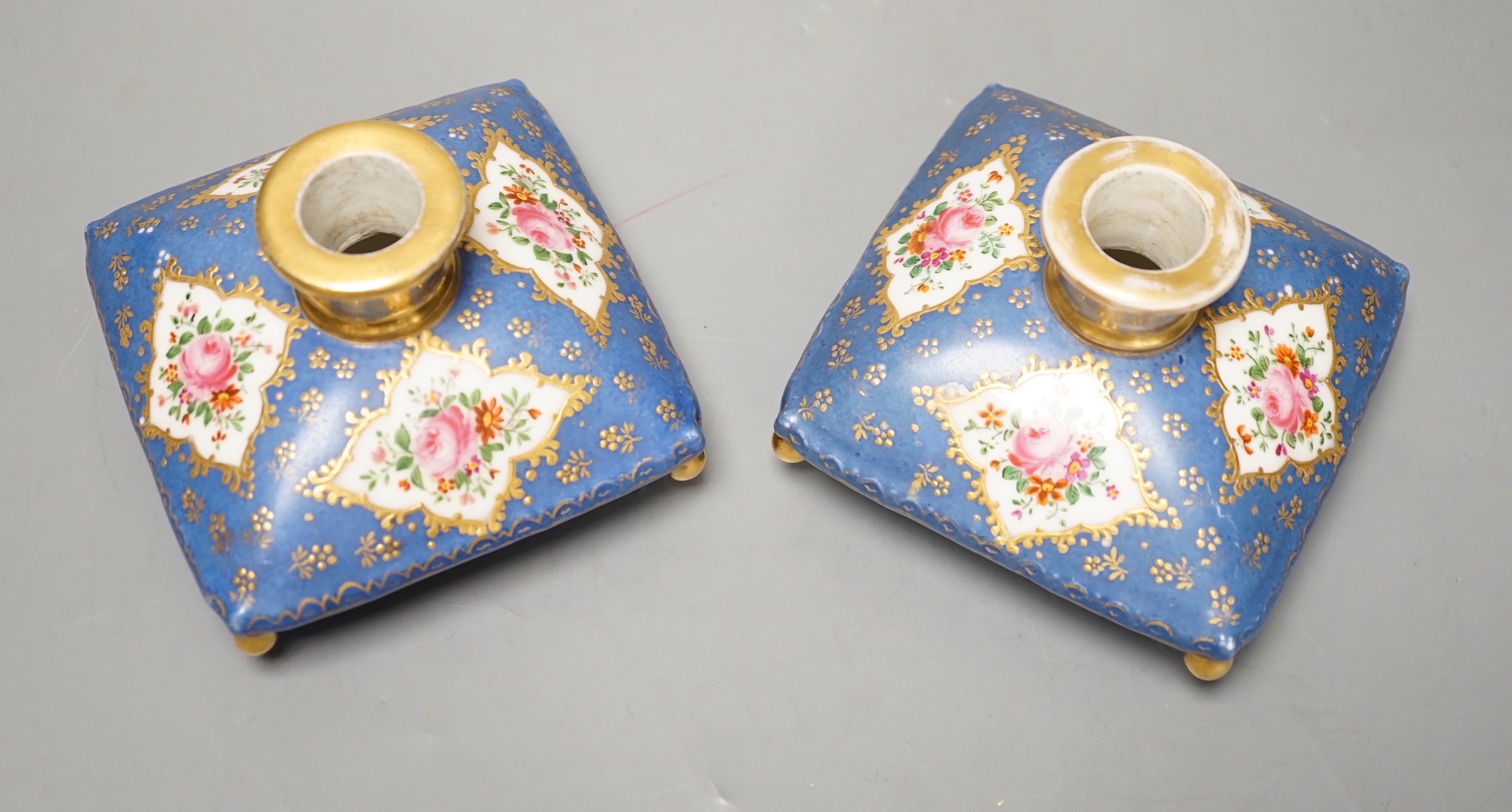 A pair of mid 19th century Paris porcelain 'cushion' shaped scent bottles decorated in Sevres style with pink roses (lacking stoppers)